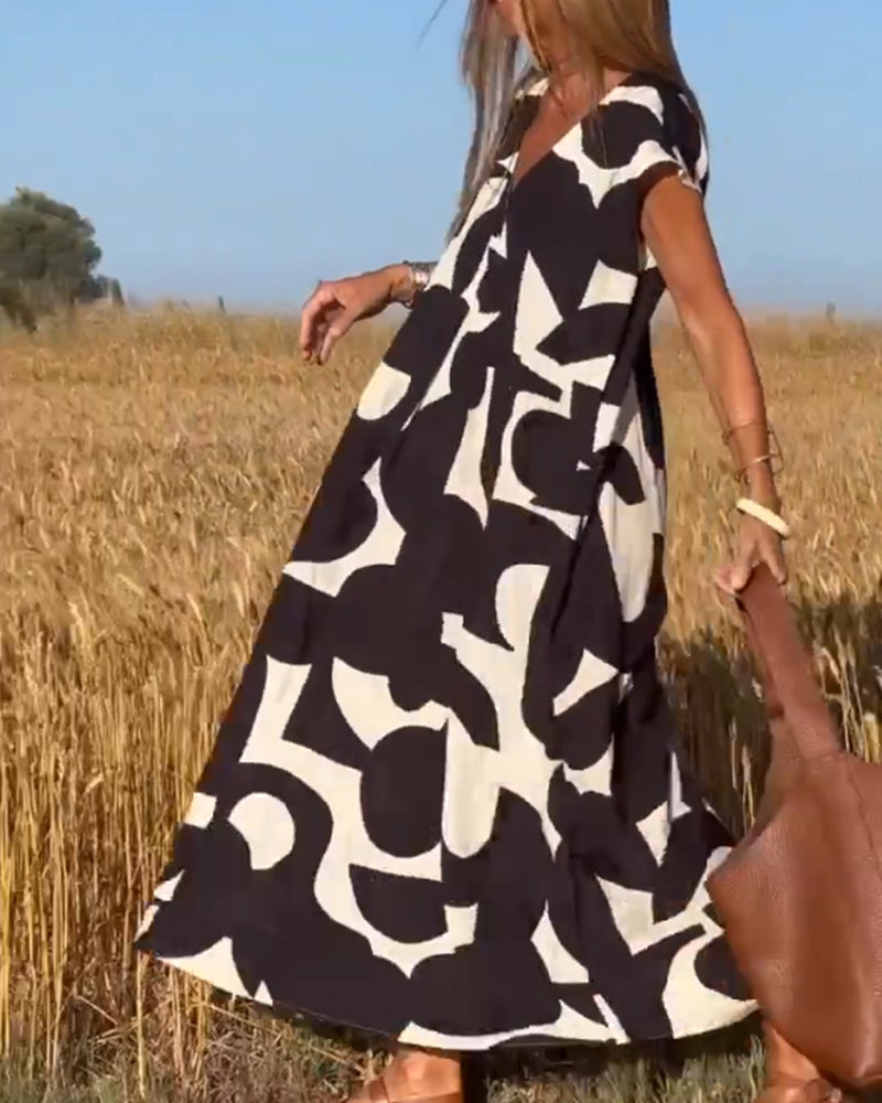 Wijdvallende damesjurk met V-hals en grafische print – LORENA WAVE - Glamorix